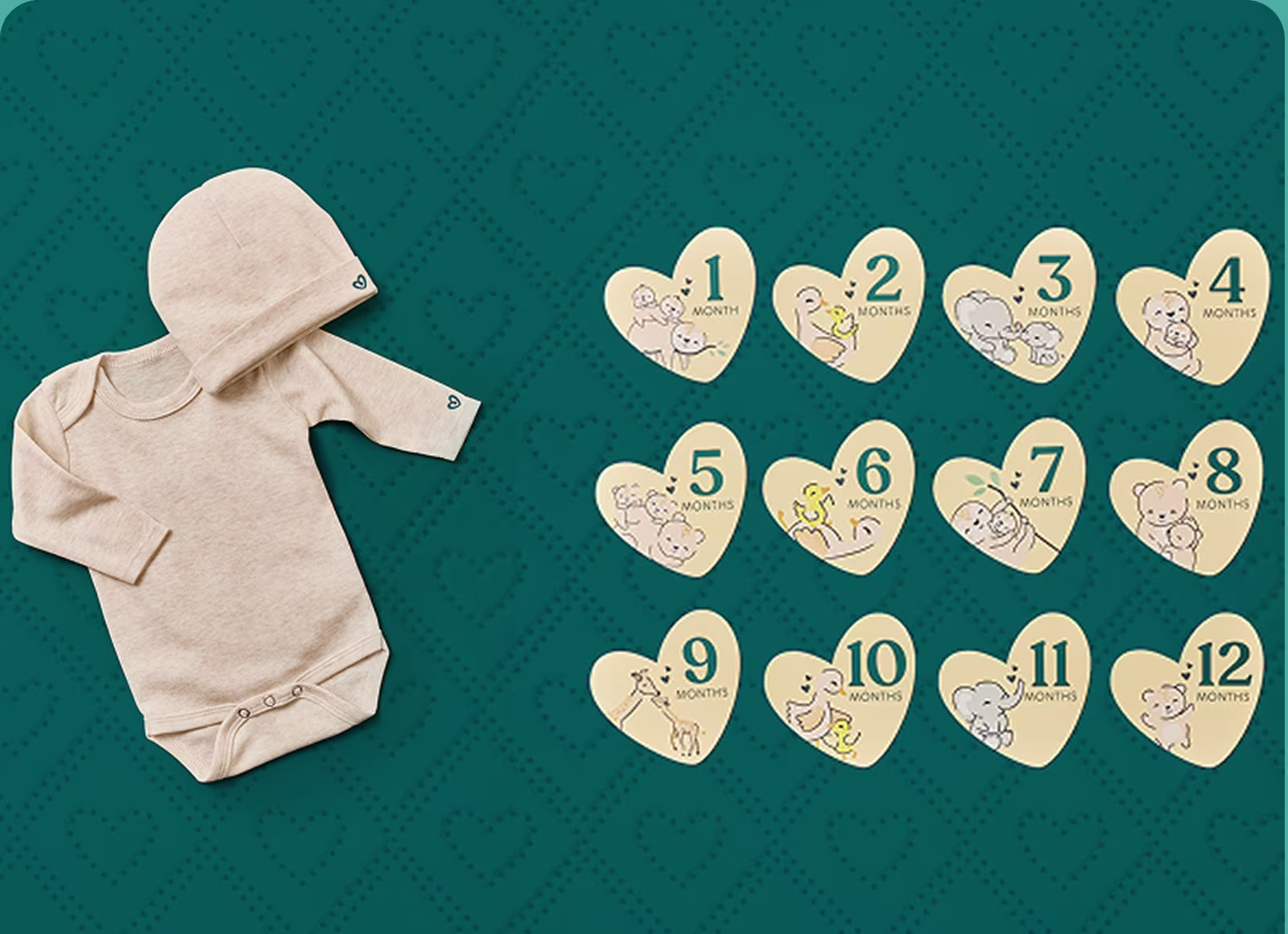 A pampers embroidered onesie and hat next to the milestone cards on a dark teal background