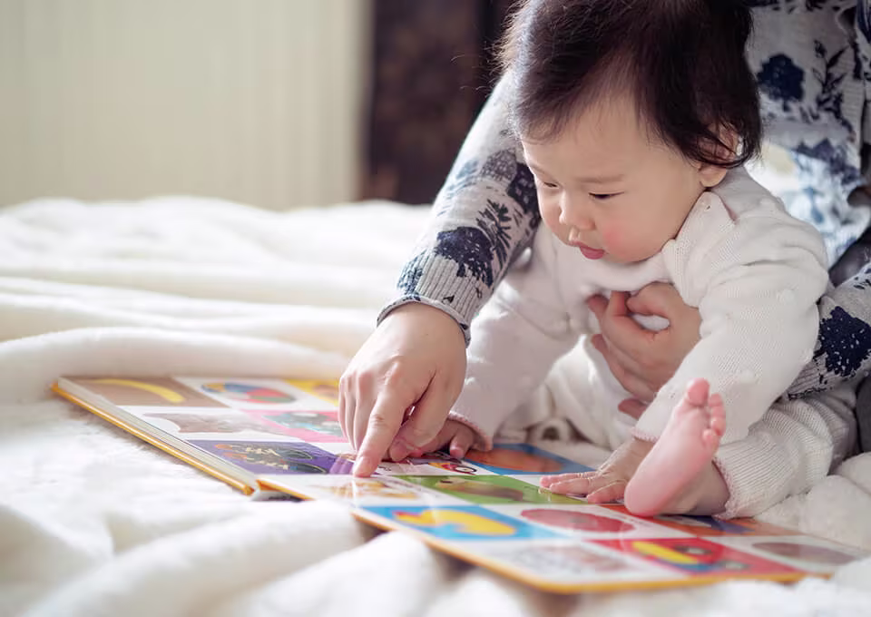 Mom teaching baby to read