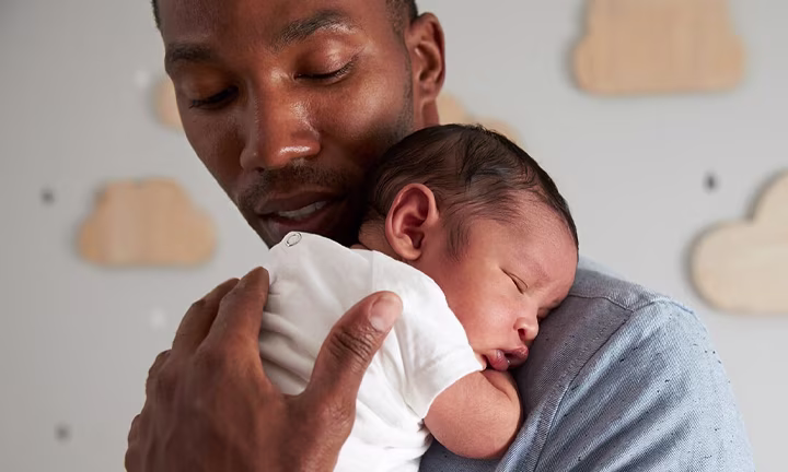 Dad nursing baby to sleep