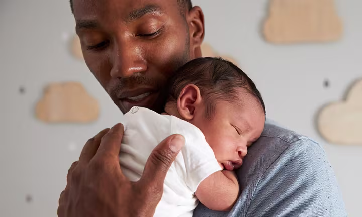 Dad nursing baby to sleep