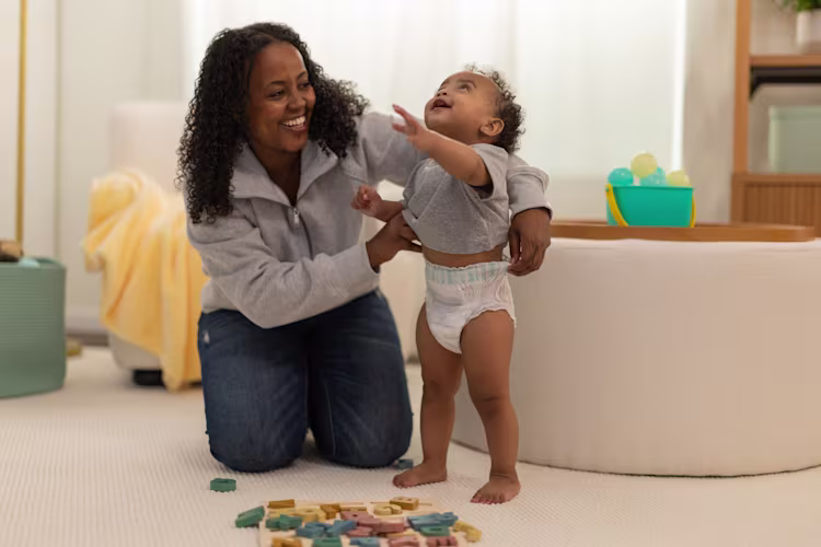 An image of mom pulling up a pampers 360 diaper