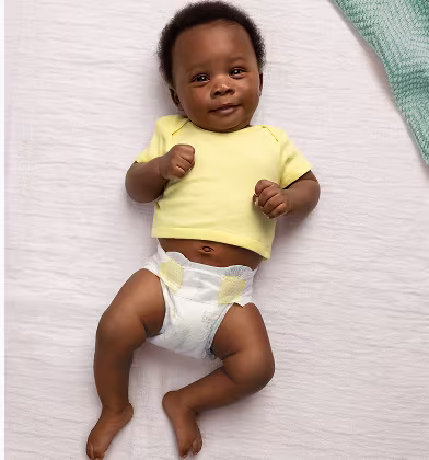 Baby laying on their back wearing a Swaddlers Ultra diaper and yellow shirt Baby laying on their back wearing a Swaddlers Ultra diaper and yellow shirt