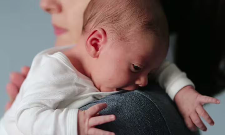 Baby Crying on Mother’s Shoulder