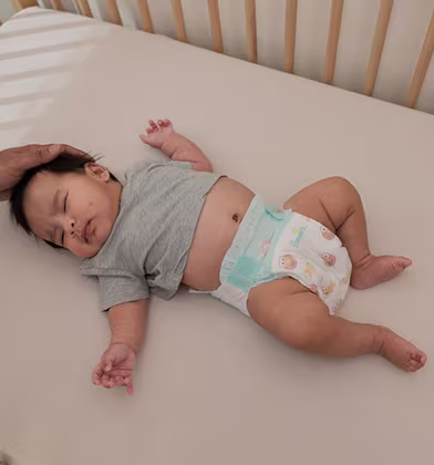 A peaceful baby sleeps soundly in a cozy crib
