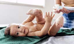 Baby lying on back during diapering