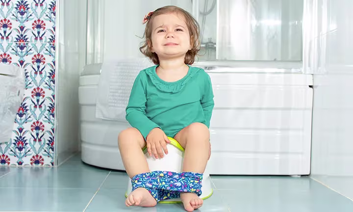 Banner image of a baby during potty training for the article how to Deal with Potty Training Regression