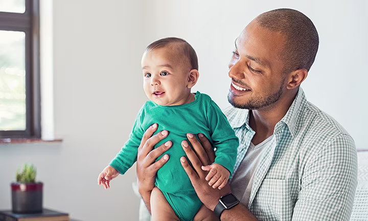 Un père travaillant à la maison avec son bébé