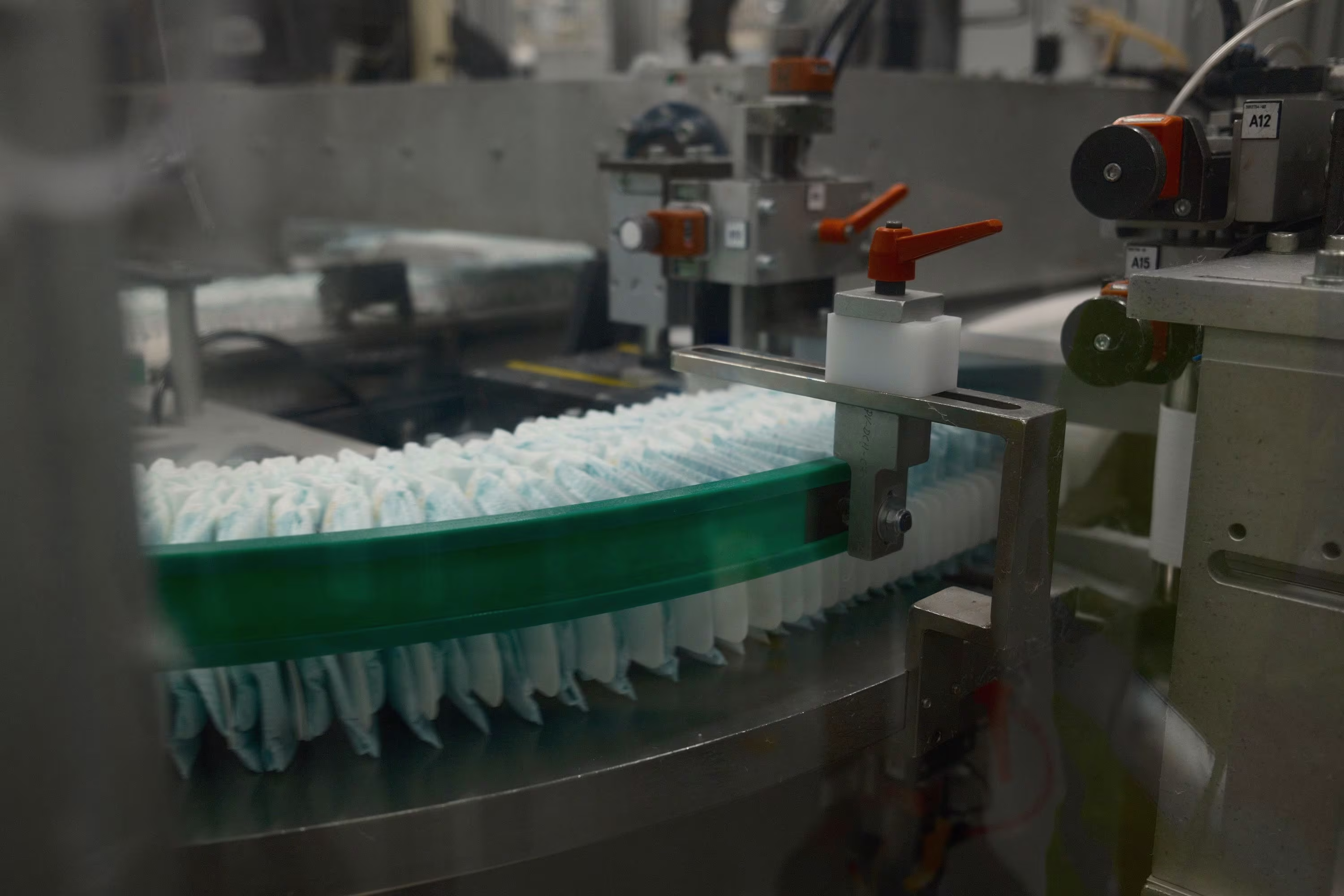 Nappies on a conveyor belt in a Pampers factory