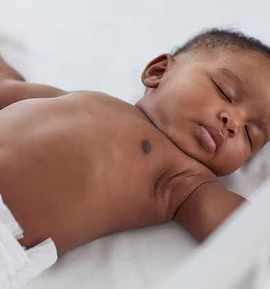 A baby sleeps on their back A baby sleeps on their back