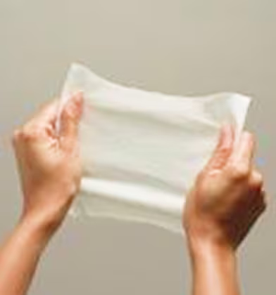 Two hands pulling a Complete Clean baby wipe to show how strong, yet soft they are