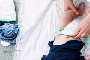 Checking diaper fits well on baby