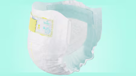 Closed Pampers taped diaper with clickable points highlighting ingredients area.