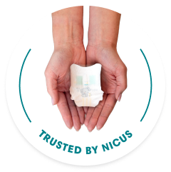 Hand holding Pampers preemie diaper
