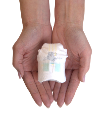 Hand holding Pampers preemie diaper