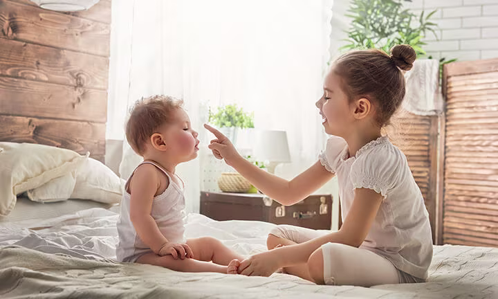 Baby playing with sister