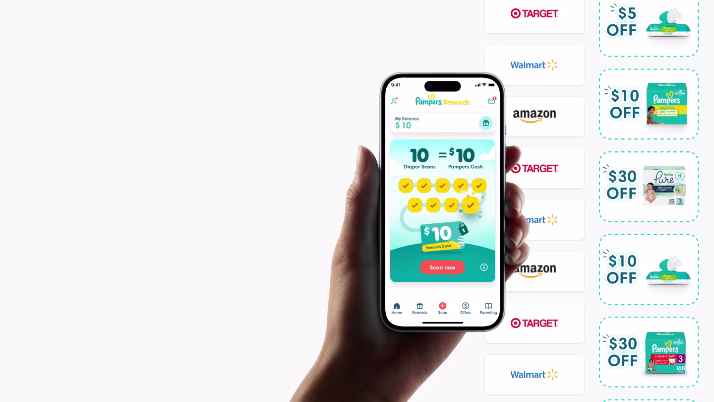 Hand holding a phone showing the Pampers rewards app homescreen