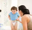 Toddler putting on training pants