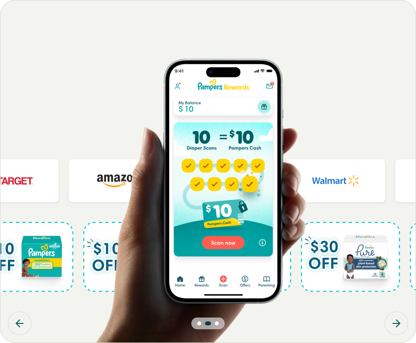 Hand holding a phone showing the Pampers rewards app homescreen
