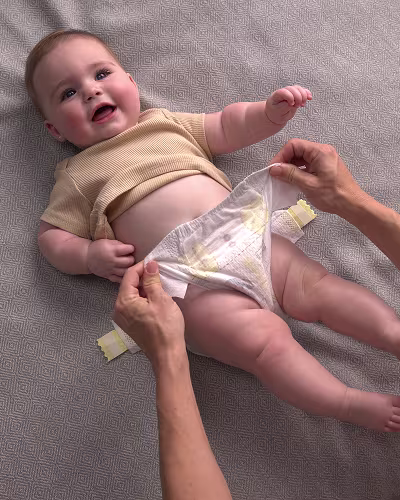 Eltern legt dem Baby eine frische Windeln an.