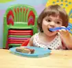 Toddler-eating--with-mum-encouraging