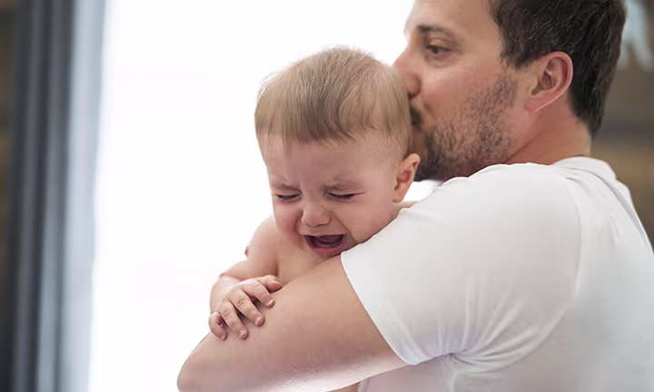Baby crying with dad