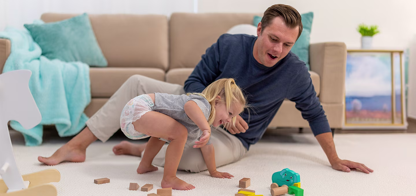  A child and father playing on the ground