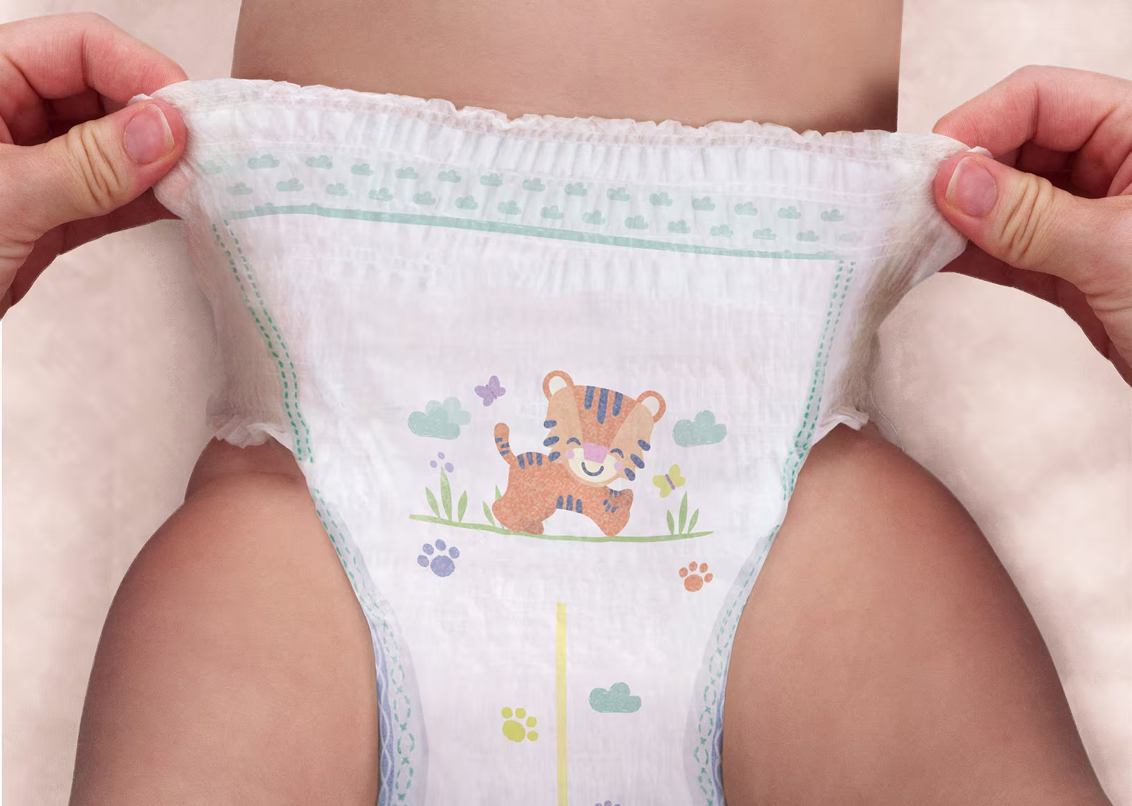 Twee handen tonen hoe eenvoudig het is om Pampers® Pants aan te trekken. Twee handen tonen hoe eenvoudig het is om Pampers® Pants aan te trekken.