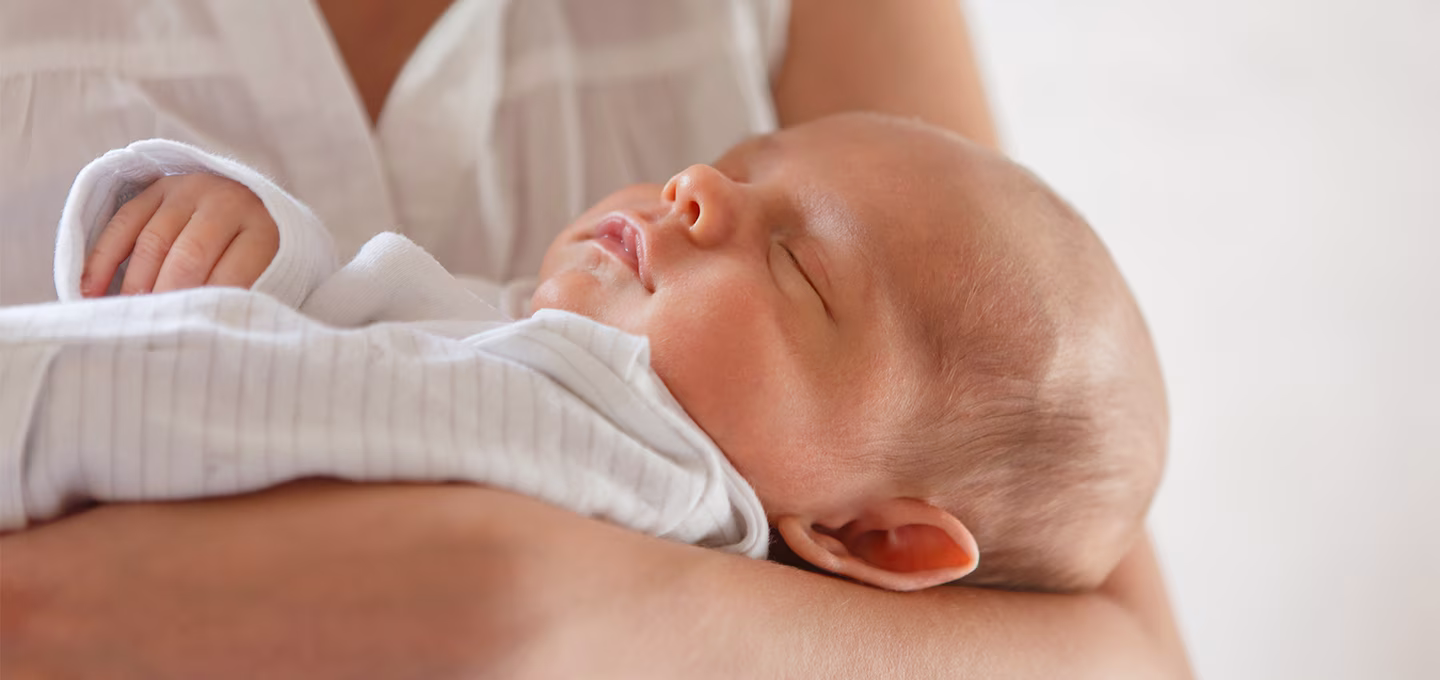  Baby sleeping in the arms 
