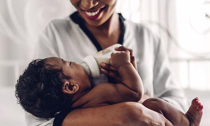 Mom feeding newborn baby