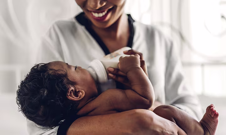 Mom feeding newborn baby