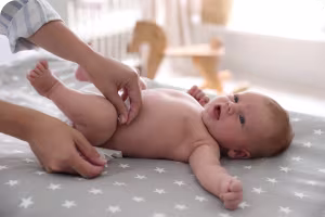 placing a fresh diaper on baby