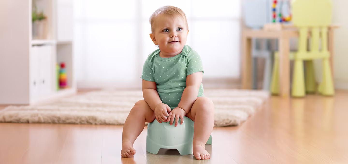 A toddler sitting on a potty