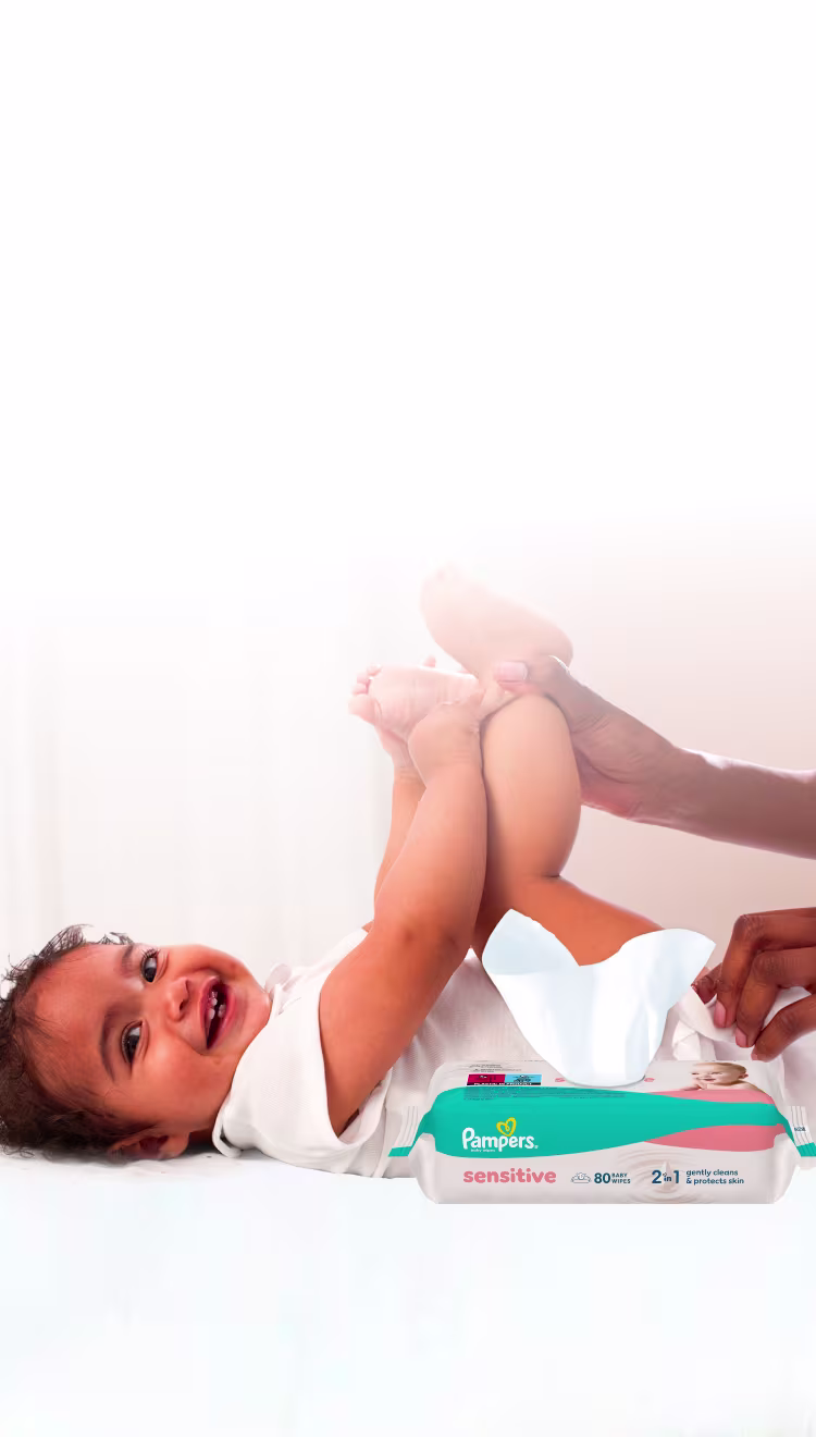 Baby liegt auf dem Rücken und wird sanft mit einem Feuchttuch gereinigt.