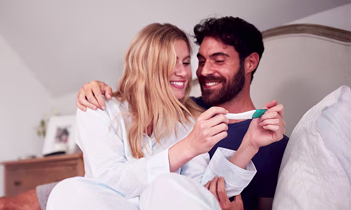 A couple looking at a pregnancy test