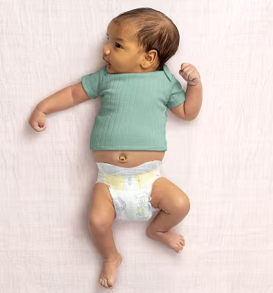 Baby laying on their back wearing a Swaddlers Ultra diaper and teal shirt Baby laying on their back wearing a Swaddlers Ultra diaper and teal shirt