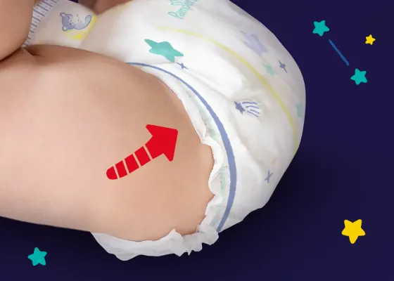 Pieluchomajtki Pampers Night Pants z czerwoną strzałką wskazującą na podwójne osłonki wokół nogawek.