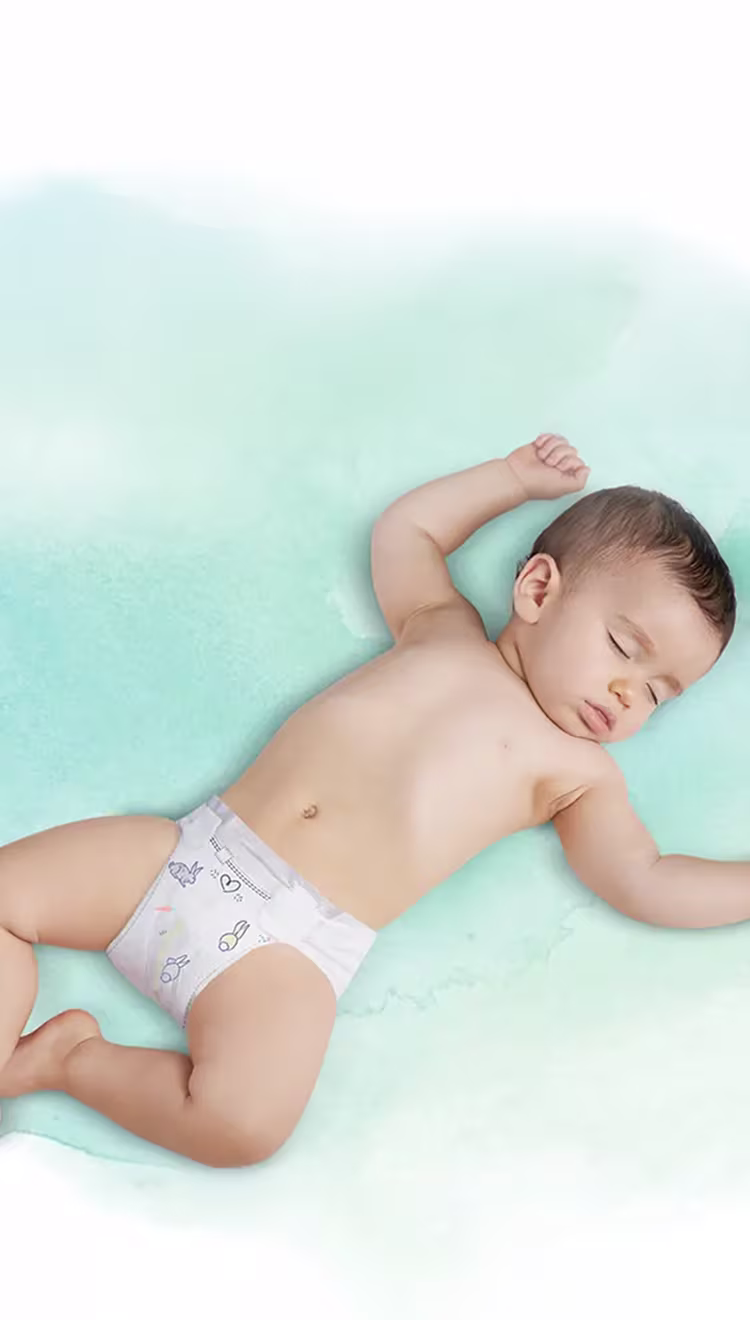 Ein schlafendes Baby, das auf dem Rücken liegt und eine Pampers-Windel trägt.