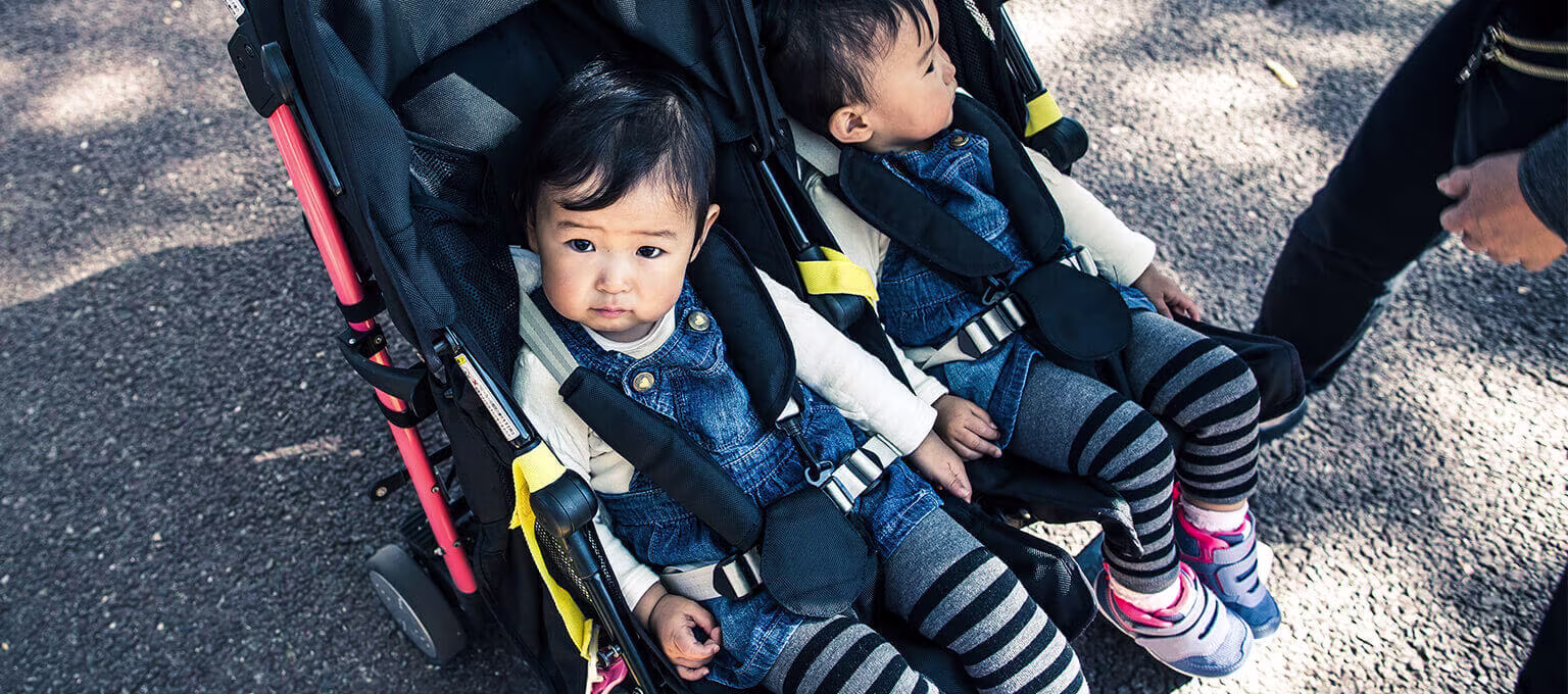 A double stroller in use, perfect for transporting two children comfortably.