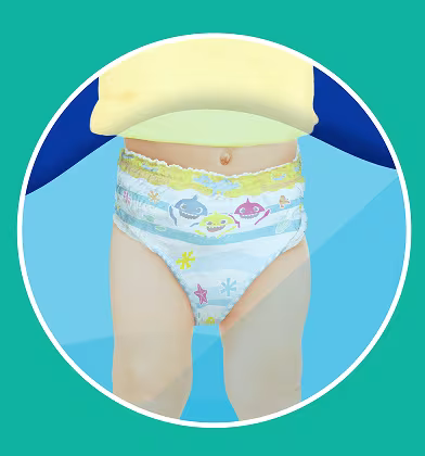 A baby wearing a Baby Shark-themed swim diaper is shown from the waist down in a cropped, circular view. A baby wearing a Baby Shark-themed swim diaper is shown from the waist down in a cropped, circular view.