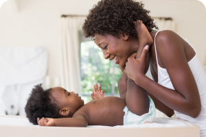 woman changing baby's diaper