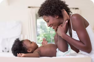 woman changing baby's diaper