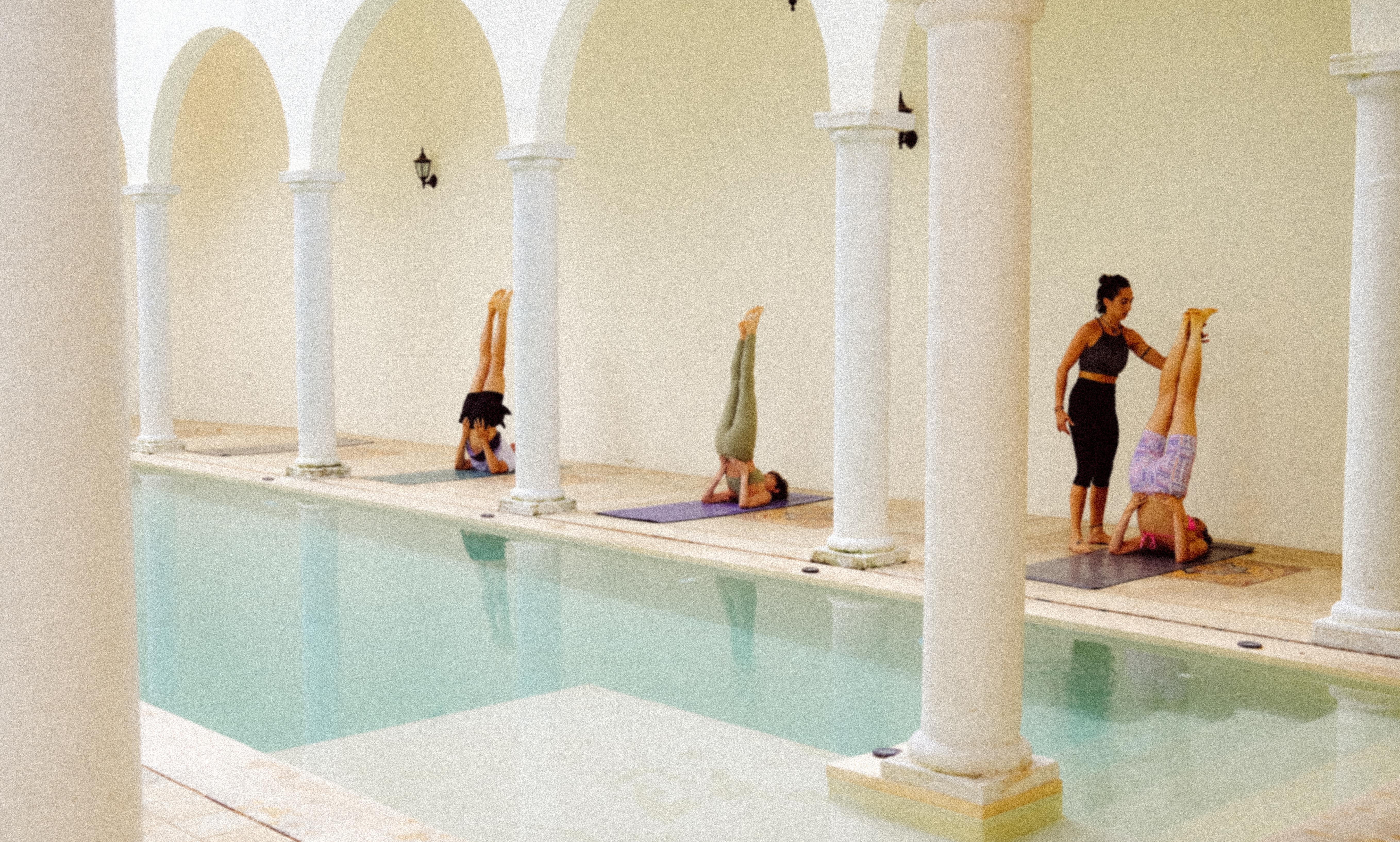 Students receiving hands on yoga instruction