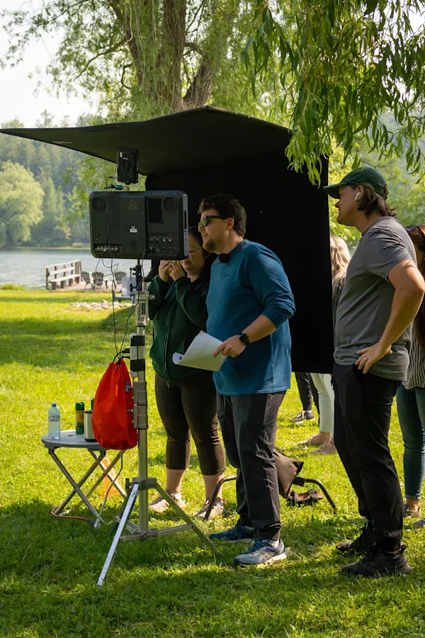 Crew watching the monitor during a lakeside shoot for Fairstone's Funny Canadian campaign