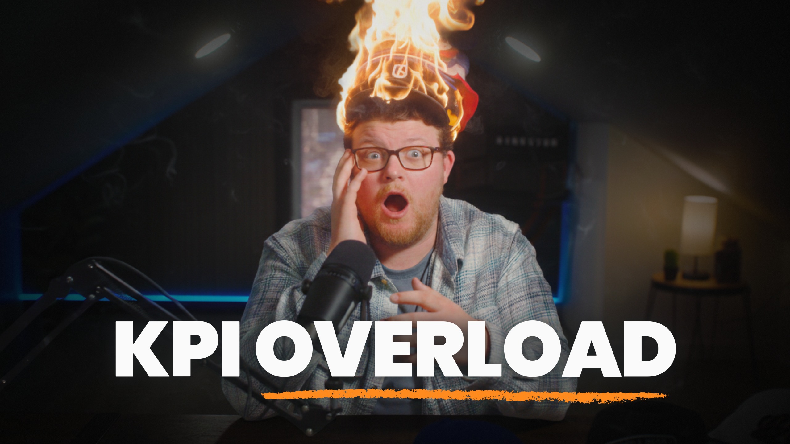 Brandon Hardy reacts in shock as the stack of hats on his head bursts into flames, above the words KPI overload