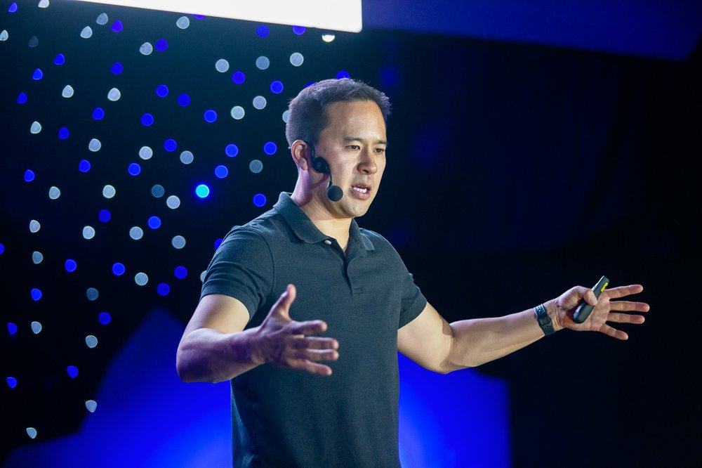 Jeremiah Owyang speaking on stage at an event. 