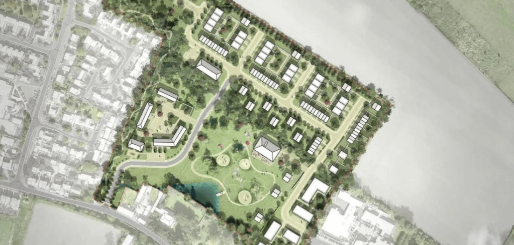 Aerial site plan rendering showing a green mixed-use development with white buildings, pathways, trees, a pond, and a waterfront nearby.