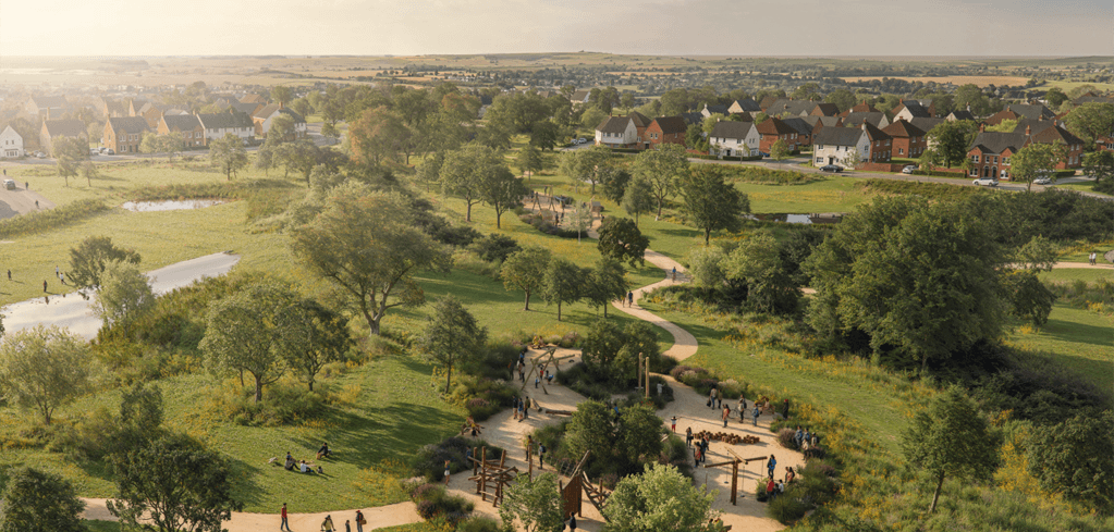 Aerial view of a green park with winding paths, trees, and people enjoying the outdoors, surrounded by a residential neighborhood.