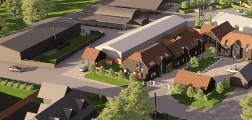 Aerial 3D rendering of a mixed-use development with brick buildings, red rooftops, green landscaping, and paved driveways.