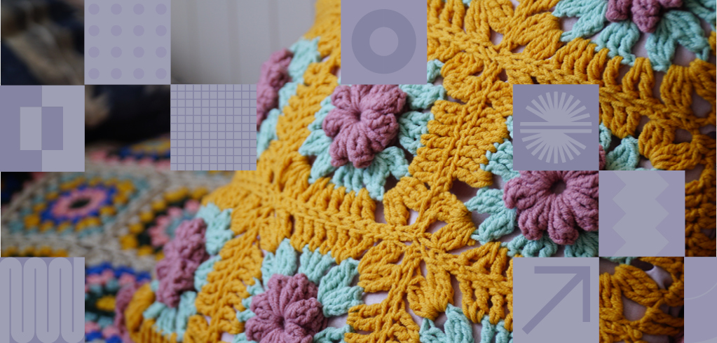 Colorful crocheted blanket with yellow star patterns and pink and blue flower details, shown in a patchwork grid layout.