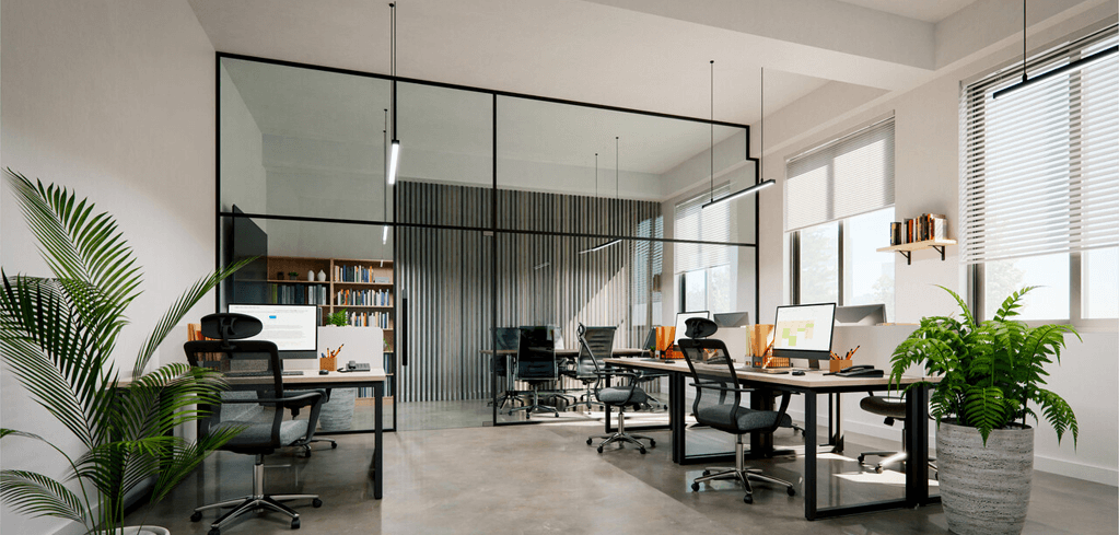 Modern office space with glass partitions, workstations with computers, office chairs, and potted plants by large windows.